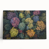 Landscape-stretched canvas artwork showcasing vibrant abstract designs with bold colors, leaning against a neutral wall, ideal for modern home decor.