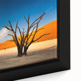 Close-up of a textured black wall art depicting the Namibian landscape on a framed canvas, featuring vibrant earthy tones.