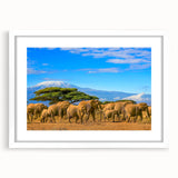 Abstract art print of African scenery in muted earth tones on a white framed canvas.