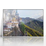 Acrylic print of Bhutanese landscape in muted earth tones, framed in white, suitable for modern art wall decor.