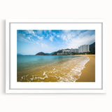 Abstract art print of Hong Kong skyline in muted gray and blue tones, framed with a white mat.