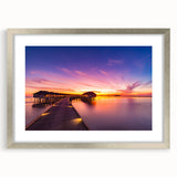 Textured abstract art print of Maldivian scenery in muted blue and green, framed in silver, ideal for bedroom decor.