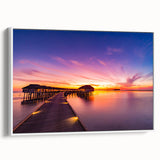 Vintage poster art of a Maldivian beach scene on a framed canvas with vivid blue and white tones.