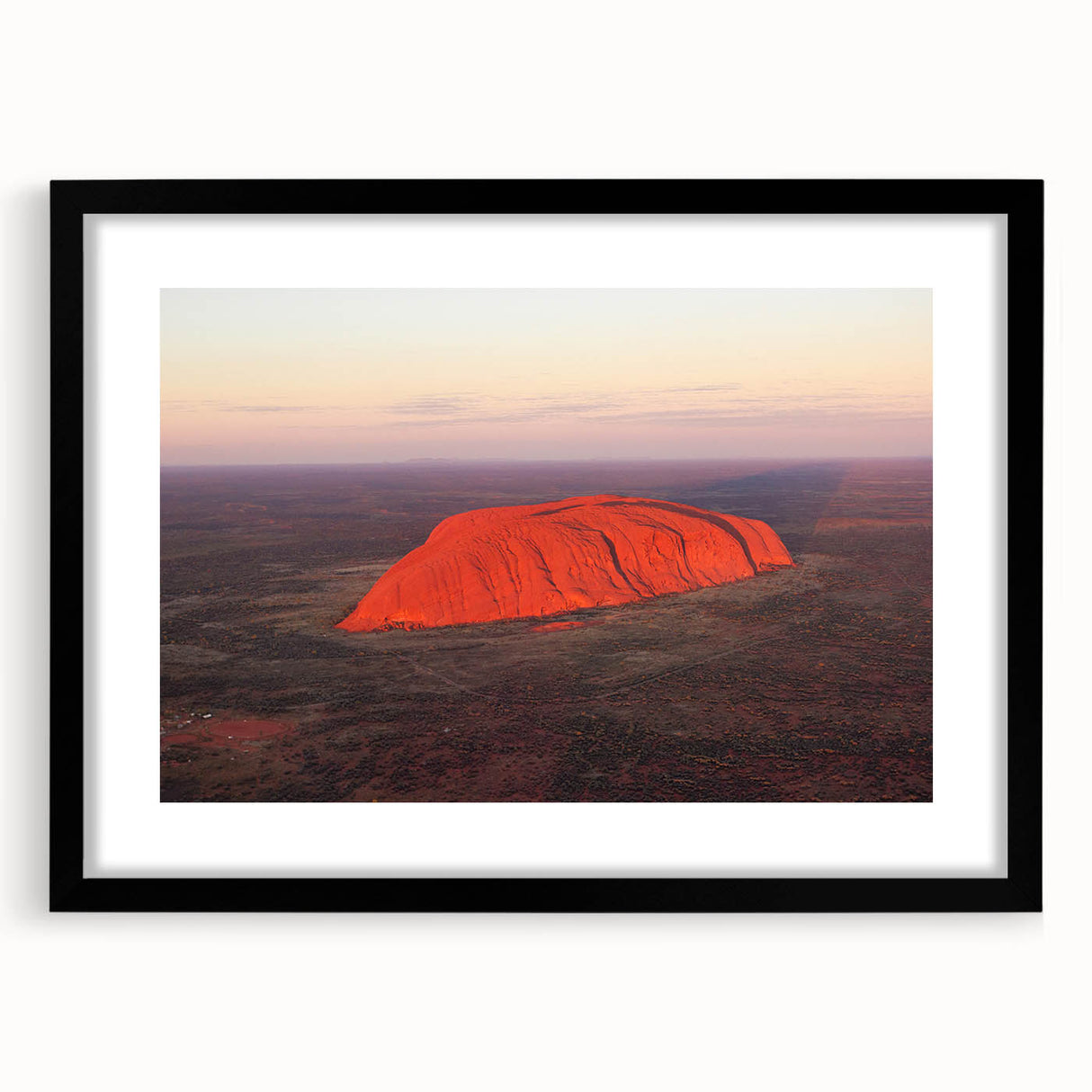 Extra large abstract art print of Ayers Rock in vibrant, colorful hues on a textured canvas, framed in black.