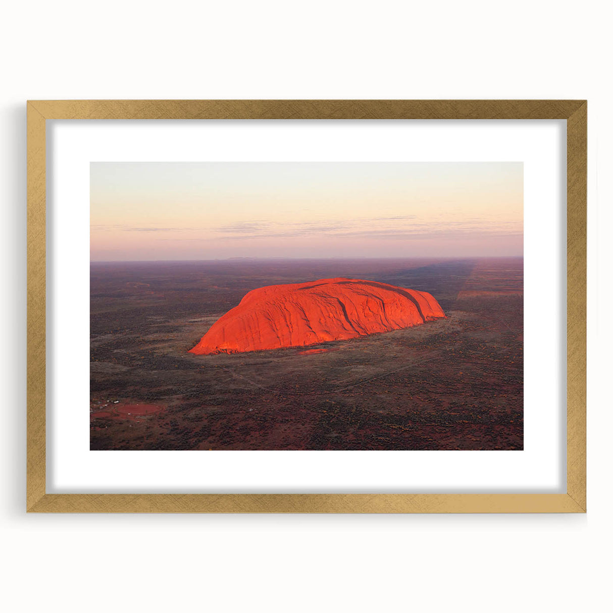 Textured art print of Ayers Rock in abstract style with earthy red and orange tones on a framed gold mat.