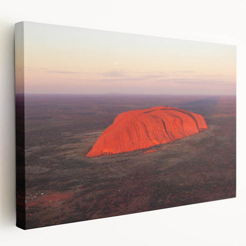 Large art print of Ayers Rock in Australia on stretched canvas, featuring earthy red and orange tones.