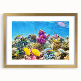 Extra large framed wall art of an abstract representation of the Great Barrier Reef in vibrant blues and greens.