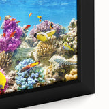 Framed canvas featuring a textured close-up of the Great Barrier Reef, with vibrant blues and greens.
