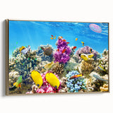 Framed canvas wall art depicting the Great Barrier Reef in muted blue and green tones, ideal for bedroom decor.