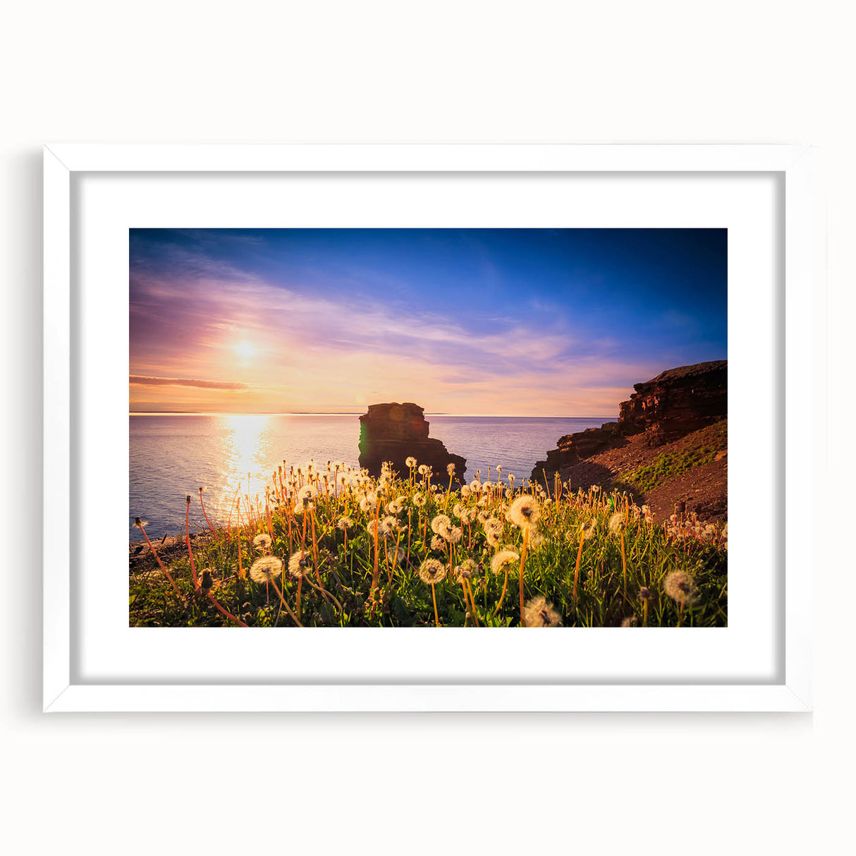 Abstract art print of Newfoundland scenery in muted blue and green tones, framed with a white mat.