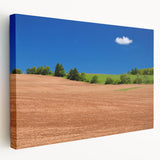 Scenic Prince Edward Island landscape on stretched canvas, featuring muted green and blue tones.