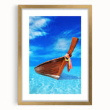 Abstract art print of a Caribbean scene in muted blue and green tones on a framed gold mat, ideal for dining room decor.