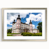 Textured art print featuring an abstract depiction of a European cityscape in muted earth tones, framed in silver.