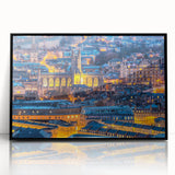 Large abstract wall art depicting a European cityscape in muted gray and blue tones, framed in black acrylic.