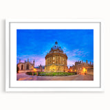 Textured art depicting an abstract European cityscape in muted gray and blue tones, framed with a white mat.