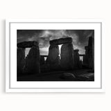 Textured art print of Stonehenge in muted earth tones, framed with a white mat, suitable for bedroom decor.