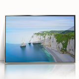 Large art print of Normandy scenery in muted green and blue tones on silver-framed acrylic.