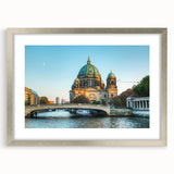 Extra large wall art of an abstract Berlin cityscape in textured shades of gray and blue, framed in silver.