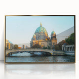 Large art print of Berlin skyline in mid-century modernist style, with muted gold and blue tones on framed acrylic.