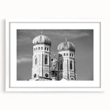 Textured abstract art print of Munich skyline in muted blues and grays on a white framed mat, suitable for bedroom decor.