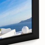 Close-up of a textured black wall art featuring a colorful Santorini scenery on a framed canvas, ideal for living room decor.