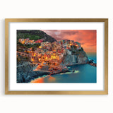 Abstract art print of Cinque Terre with vibrant seaside colors on a gold-framed canvas, ideal for dining room decor.