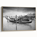 Framed canvas wall art featuring a vintage-style landscape painting of Venice in muted gold and black tones.