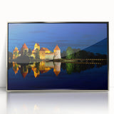 Large art print of a European Lithuanian scenery in muted green and blue tones on silver-framed acrylic.