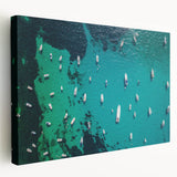 Large art print of the Mediterranean Sea coastline in soft blue and white tones on stretched canvas.