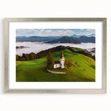 Abstract art print of a European landscape in muted green and blue tones, framed with a silver mat.