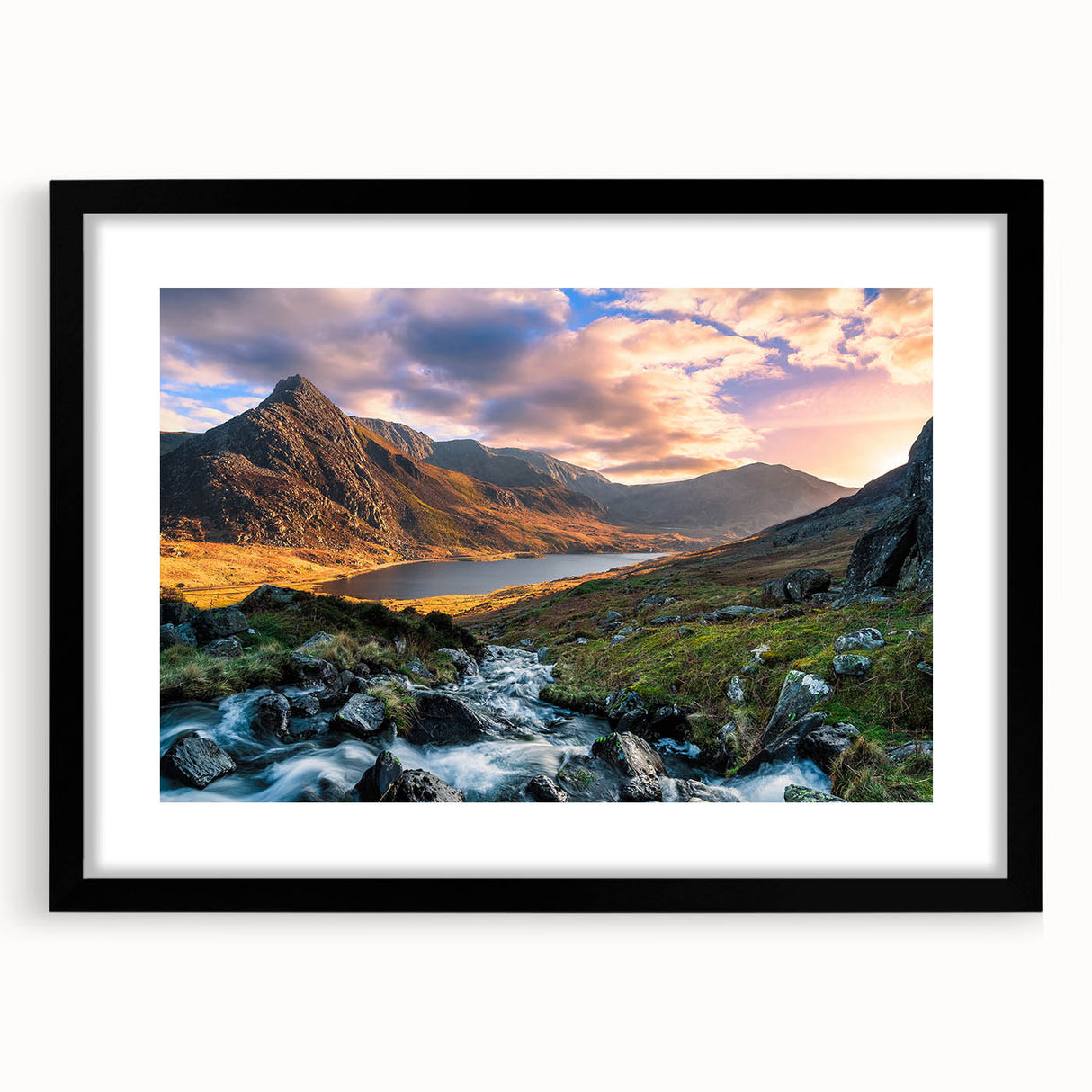 Abstract art print of a colorful Welsh landscape in vibrant hues on a large framed canvas, ideal for living room decor.