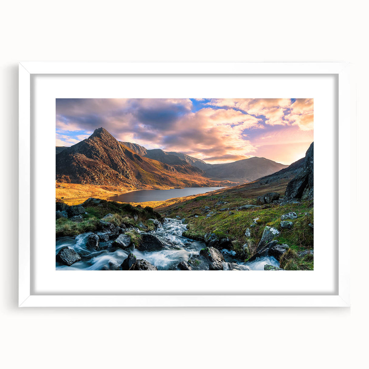 Abstract art print of a Welsh landscape in muted green and blue tones on a framed white mat, suitable for dining room decor.
