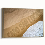 Framed canvas depicting a vintage-style landscape of Cabo San Lucas with muted gold and black tones.