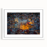 Abstract art print of Guanajuato with vibrant colors on a framed white mat, ideal for dining room decor.