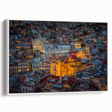 Vintage poster art of Guanajuato, Mexico on a framed canvas, featuring vibrant colors against a black background.