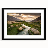 Abstract art print depicting a colorful, textured Middle Eastern scenery on a large black-framed canvas.