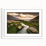 Abstract art print featuring muted earth tones of a Middle Eastern landscape on a framed white mat.