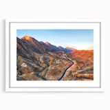 Abstract art print depicting a Middle Eastern desert scene in muted earth tones, framed with a white mat.