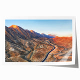 Rolled print of Middle Eastern Iraqi landscape featuring soft floral elements in muted earth tones.