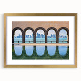 Abstract art print of a Middle Eastern scenery in gold frame with mat, featuring textured brush strokes in earth tones.