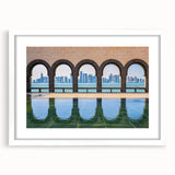 Abstract art print of a Middle Eastern scenery in muted earth tones on a framed white mat, ideal for dining room decor.