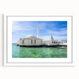 Abstract art print depicting a stylized Saudi Arabian landscape in muted earth tones, framed with a white mat.