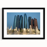 Abstract art print of Abu Dhabi skyline in vibrant colors on a large textured canvas, framed in black.