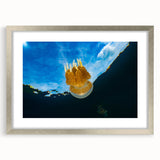 Textured abstract art print of oceanic scenery in muted blue and gray tones, framed with a silver mat.