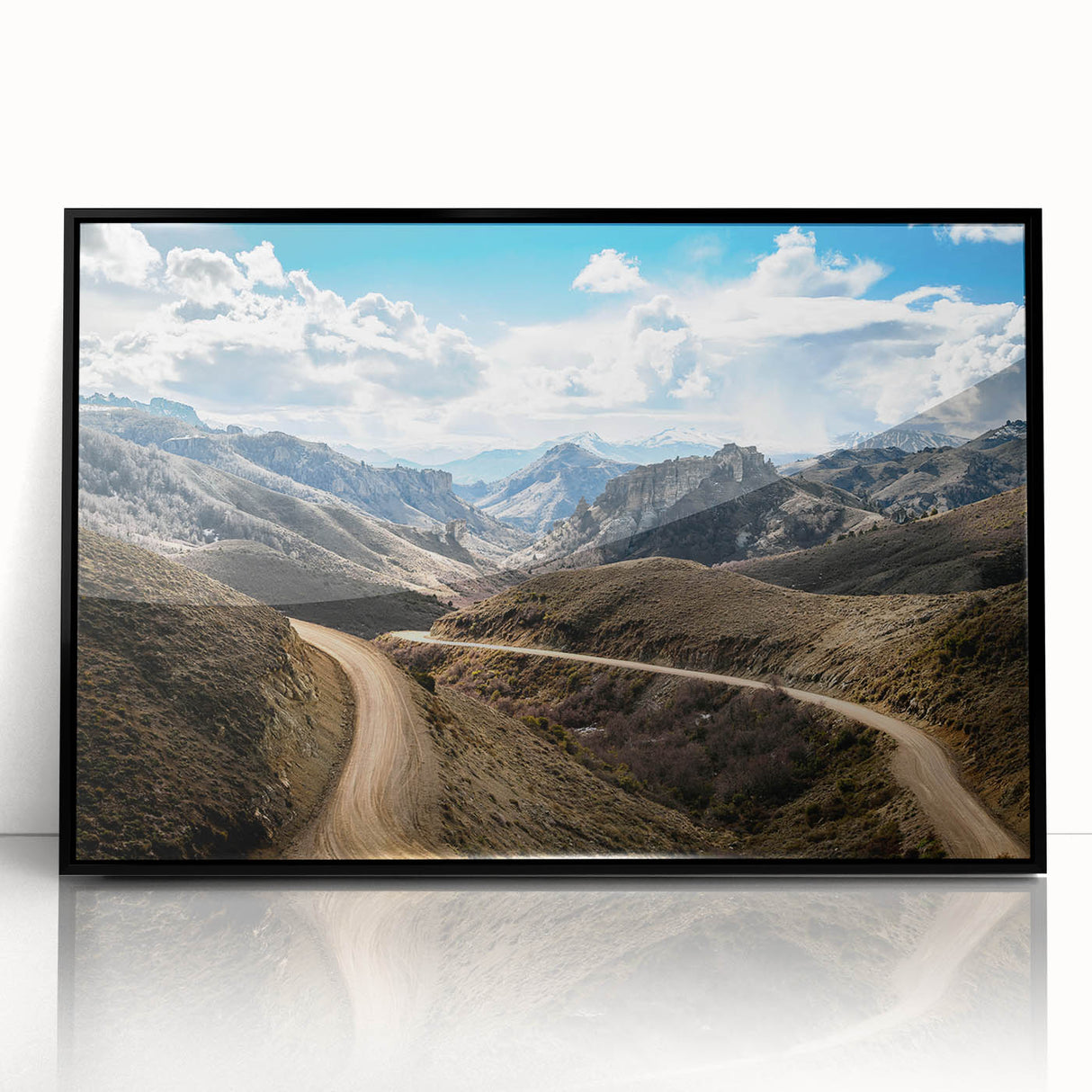 Large abstract wall art of an Argentine landscape in muted earth tones, framed in black acrylic.