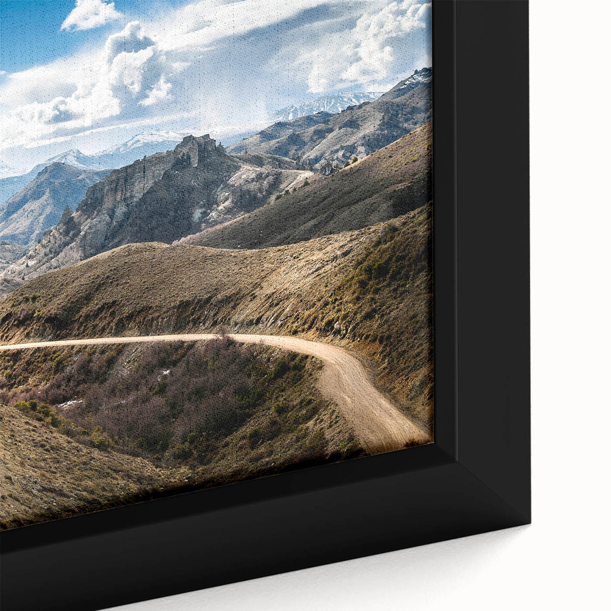 Close-up of a textured black wall art depicting a colorful Argentinian landscape on a framed canvas.