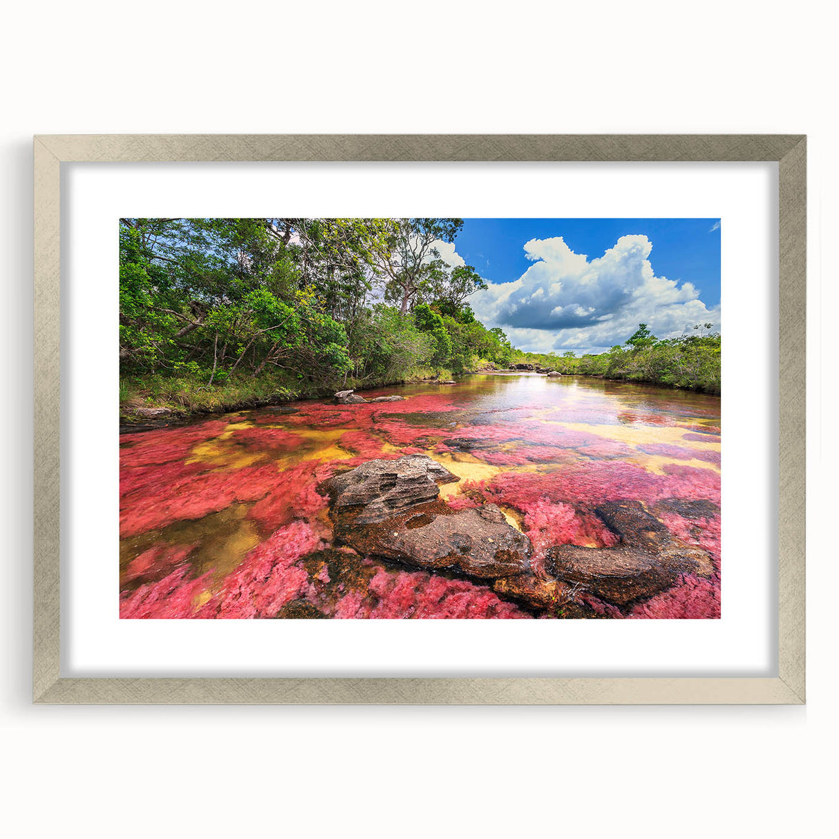 Textured abstract art print of a Colombian landscape in muted earth tones, framed in silver, suitable for bedroom decor.