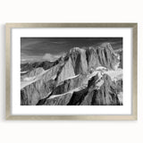 Textured abstract art print of Denali, Alaska in muted earth tones on a silver-framed mat, suitable for bedroom decor.
