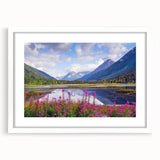 Abstract art print of Alaskan scenery in muted blue and gray tones, framed with a white mat, ideal for dining room decor.