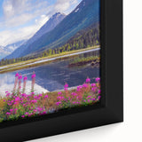 Close-up of a textured black wall art depicting an Alaskan landscape on a framed canvas, featuring a colorful palette.